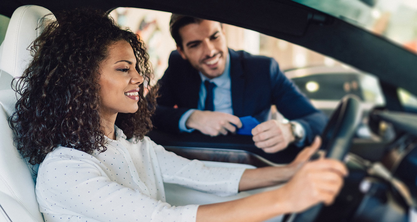 Young woman in new car