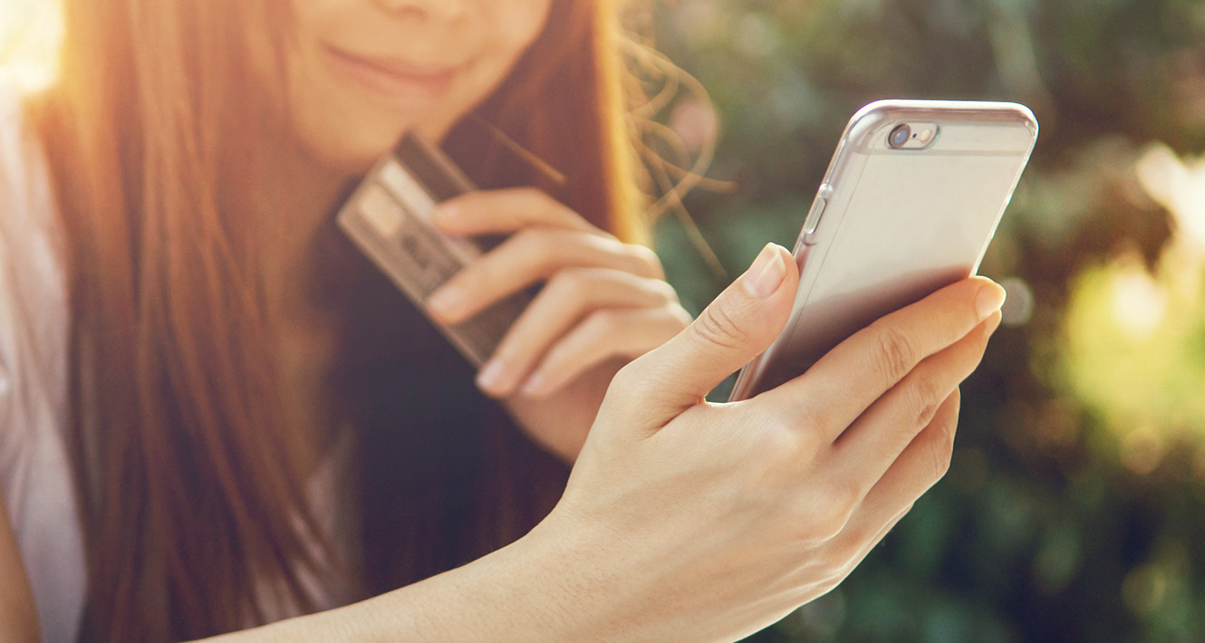 Girl with credit card on phone