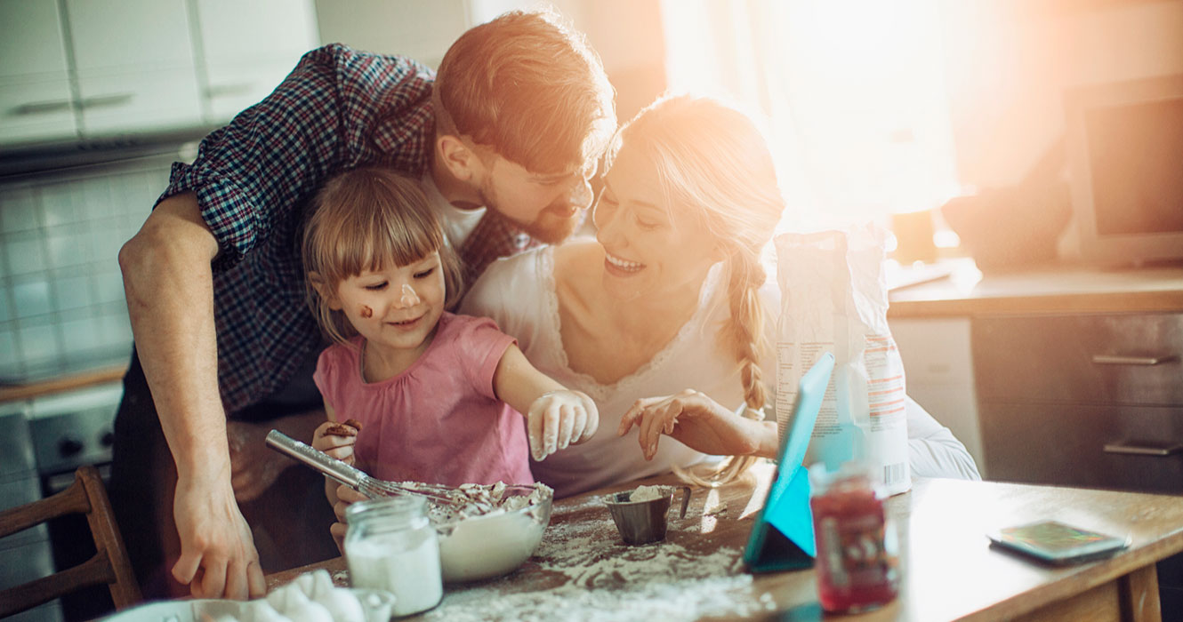 Family cooking together in their home kitchen