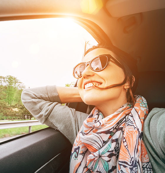 Happy woman riding in a car
