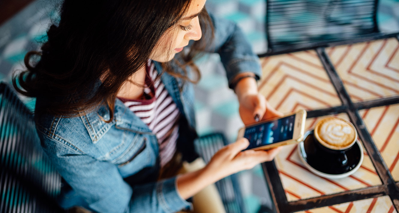 Woman using phone at coffee shop