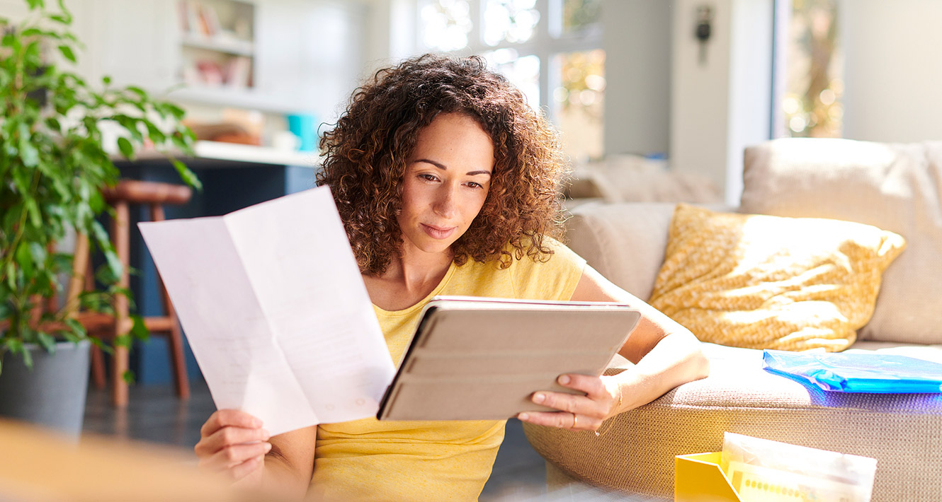 Young woman paying bills on tablet